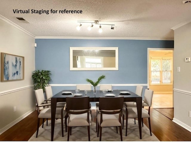 dining space with crown molding, hardwood / wood-style floors, and a textured ceiling