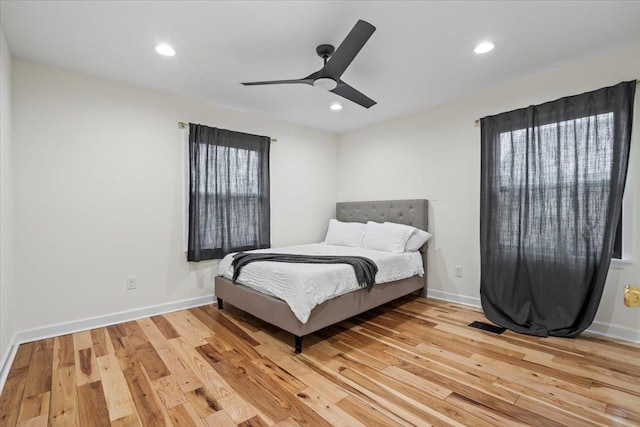 bedroom with ceiling fan and light hardwood / wood-style flooring