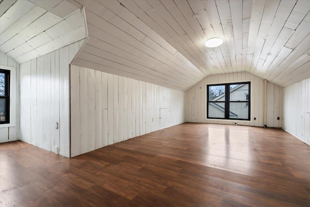 additional living space with vaulted ceiling, hardwood / wood-style floors, wood ceiling, and wood walls