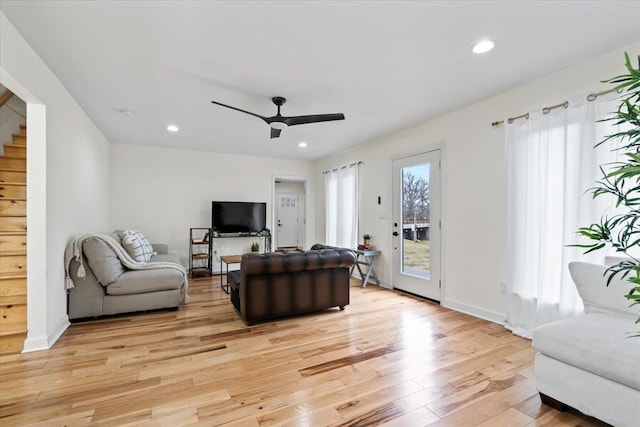 living room featuring ceiling fan and light wood-type flooring