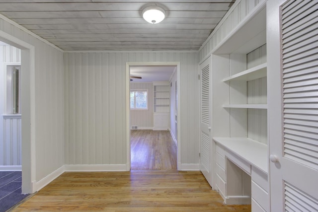 corridor with wood ceiling and light hardwood / wood-style floors