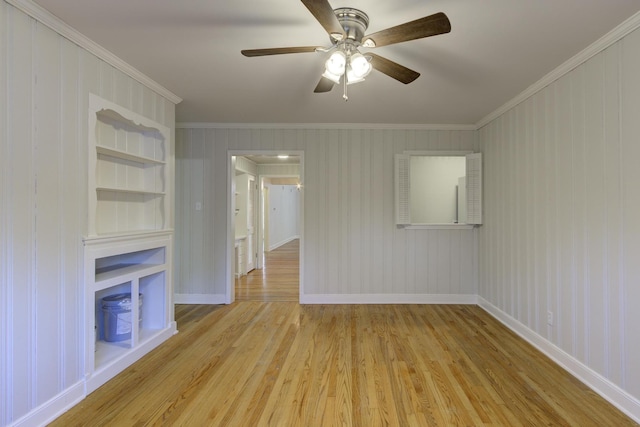 unfurnished living room with ceiling fan, ornamental molding, light hardwood / wood-style flooring, and built in features