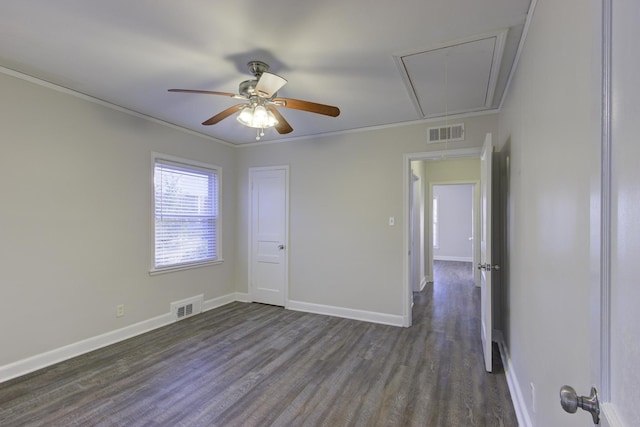 empty room with dark hardwood / wood-style flooring, crown molding, and ceiling fan