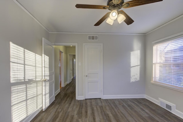 unfurnished room with crown molding, dark hardwood / wood-style floors, and ceiling fan