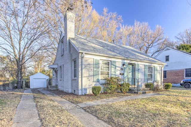 bungalow-style house featuring a garage, an outdoor structure, and a front lawn