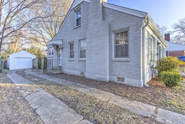 view of side of home with a garage and an outdoor structure