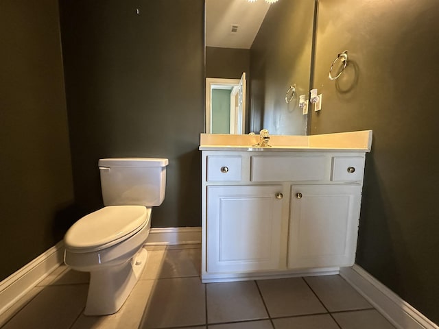 bathroom with vanity, tile patterned floors, and toilet