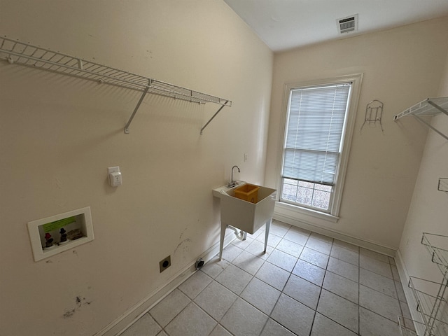 laundry room featuring light tile patterned floors, hookup for a washing machine, and hookup for an electric dryer