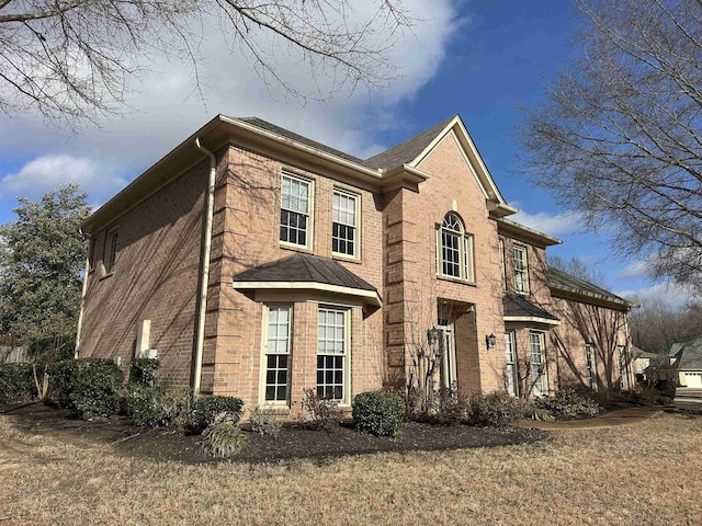 view of home's exterior with a lawn