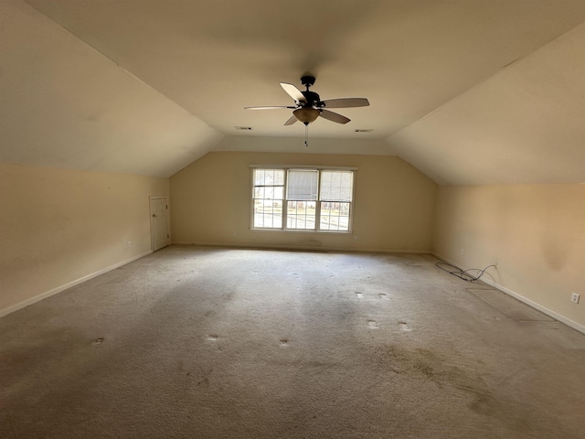 additional living space featuring ceiling fan, carpet floors, and vaulted ceiling