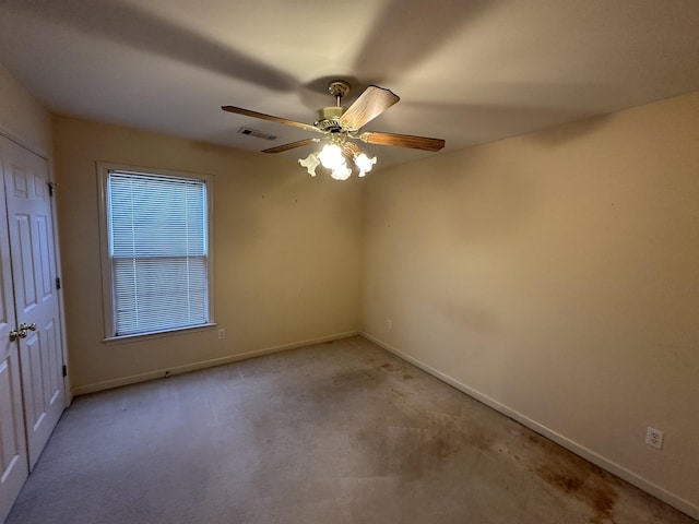 unfurnished room featuring light carpet and ceiling fan