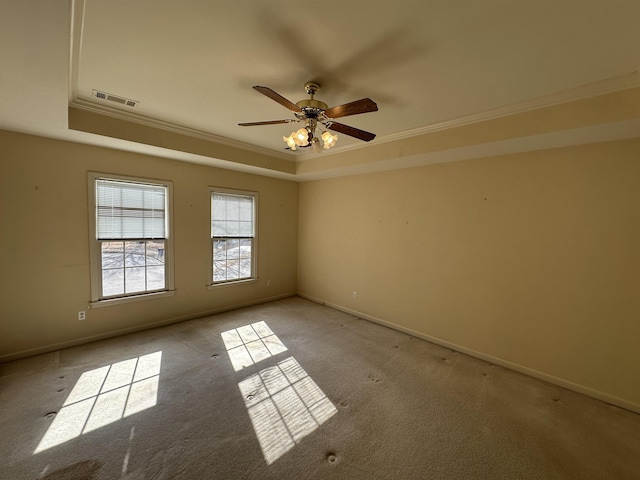 unfurnished room featuring crown molding, light colored carpet, a raised ceiling, and ceiling fan