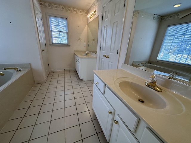 bathroom featuring vanity, a washtub, and tile patterned floors