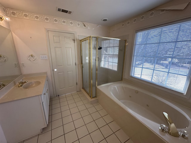 bathroom with tile patterned floors, vanity, and independent shower and bath