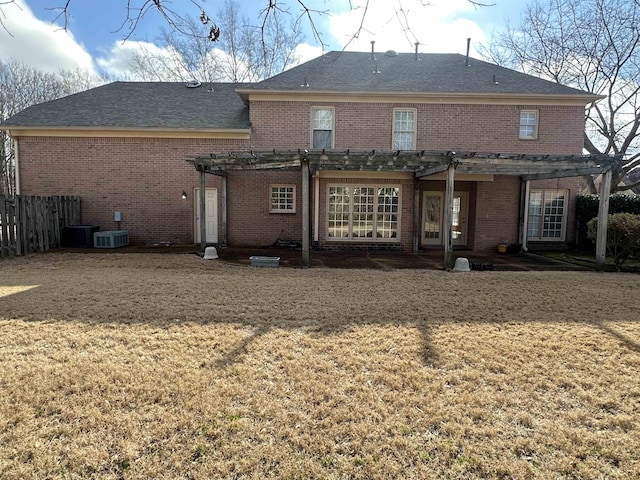 rear view of property featuring a lawn and a pergola