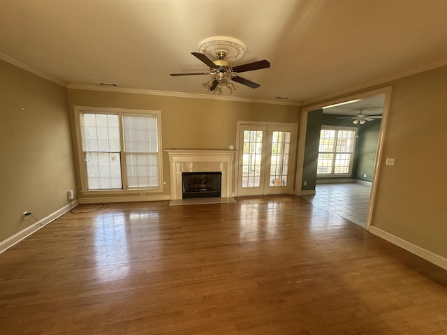 unfurnished living room with crown molding, wood-type flooring, and a fireplace