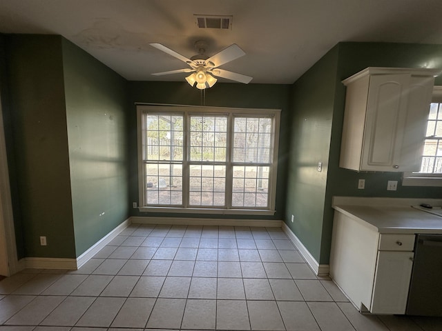 unfurnished dining area featuring light tile patterned flooring and ceiling fan