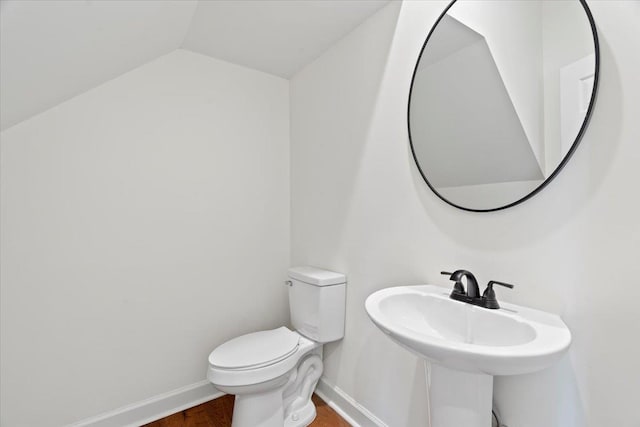 bathroom with vaulted ceiling and toilet