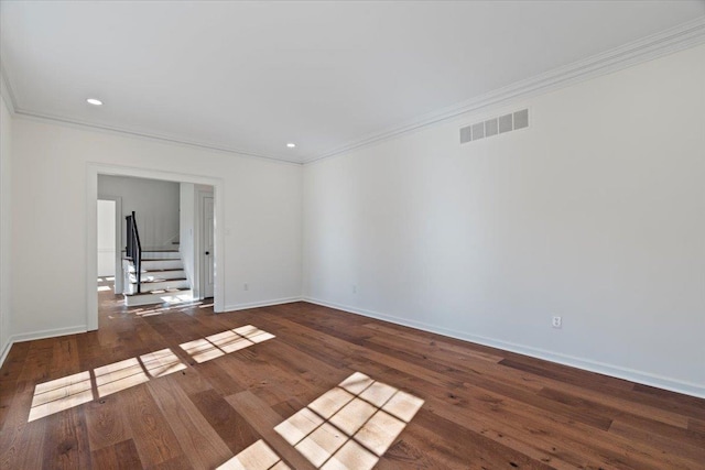 empty room featuring crown molding and dark hardwood / wood-style flooring