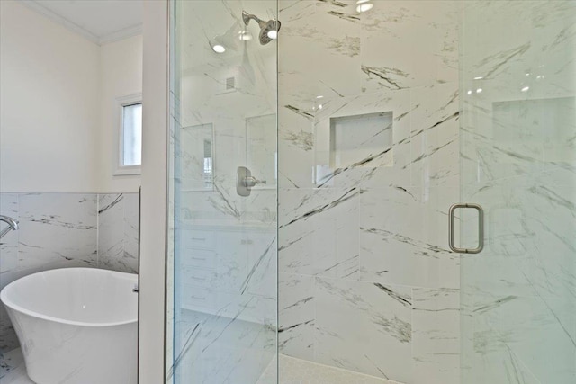 bathroom with tile walls, crown molding, and separate shower and tub