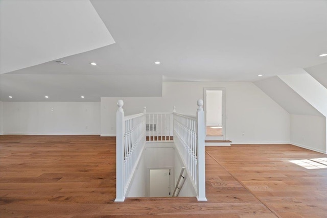 bonus room featuring vaulted ceiling and light wood-type flooring