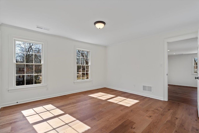 spare room with wood-type flooring