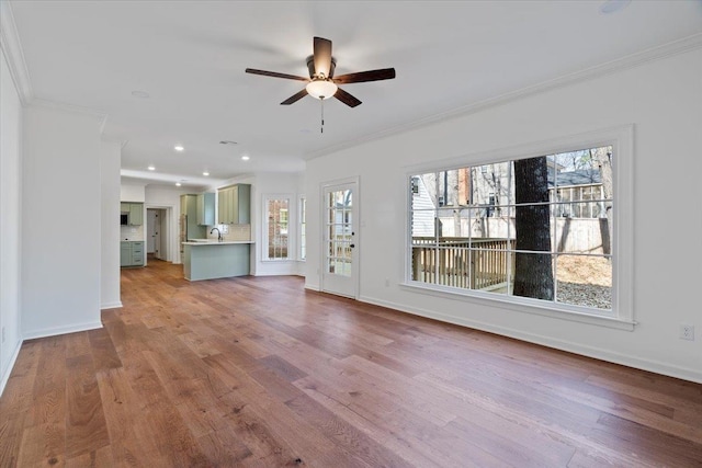 unfurnished living room featuring crown molding, ceiling fan, and light wood-type flooring