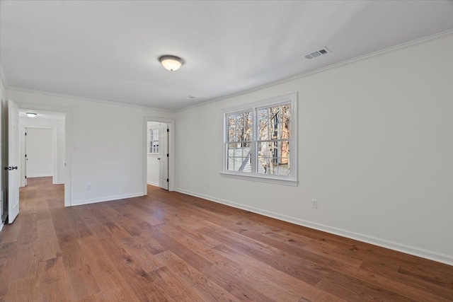 unfurnished room featuring crown molding and hardwood / wood-style flooring