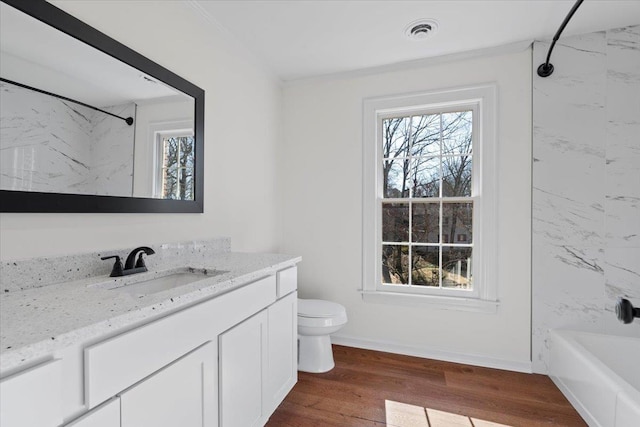 full bathroom featuring vanity, hardwood / wood-style floors, tiled shower / bath, and a healthy amount of sunlight