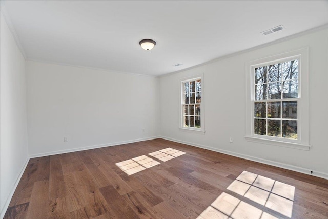 spare room featuring hardwood / wood-style flooring and crown molding