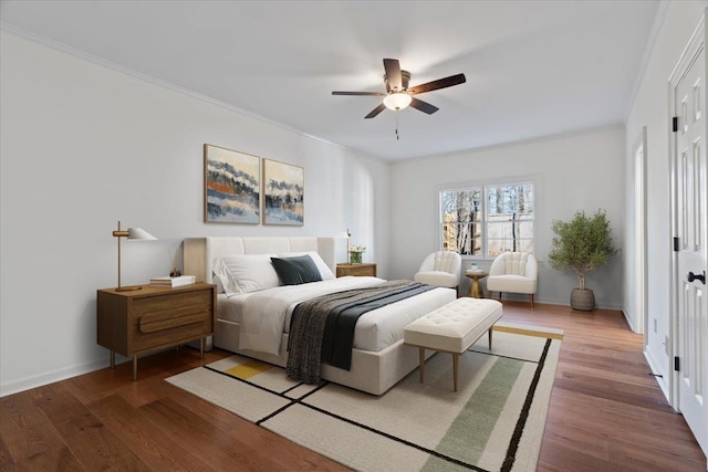 bedroom featuring hardwood / wood-style flooring, crown molding, and ceiling fan