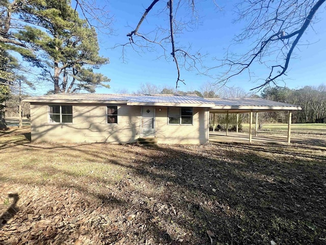 rear view of property featuring a lawn