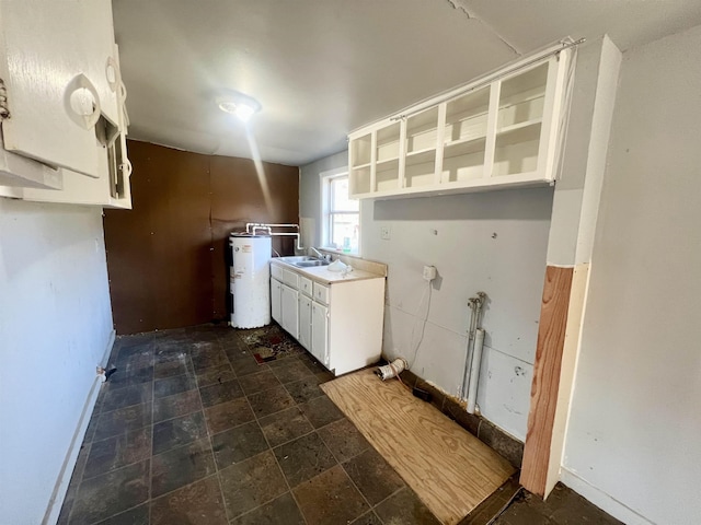 laundry area featuring water heater and sink