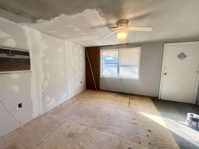 spare room featuring ceiling fan and a wall mounted air conditioner