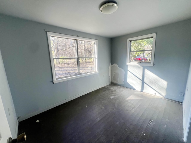 unfurnished room with dark hardwood / wood-style floors