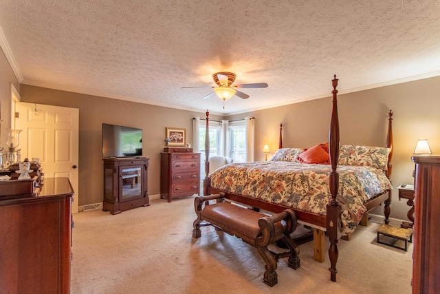 bedroom with crown molding, light carpet, a textured ceiling, and ceiling fan