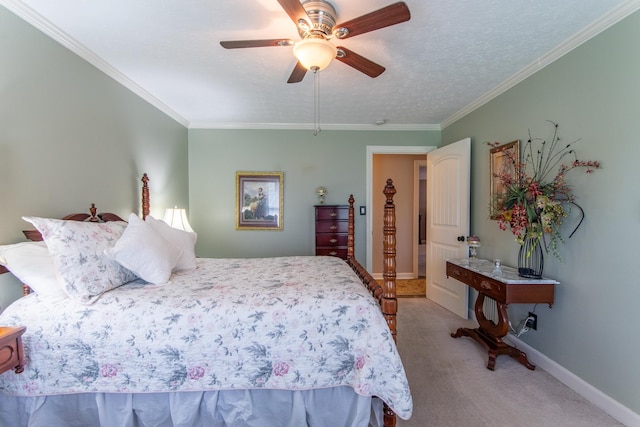 carpeted bedroom featuring ceiling fan, ornamental molding, and a textured ceiling