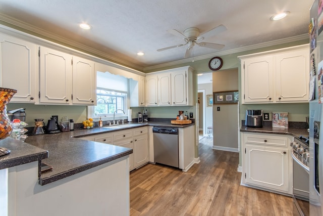 kitchen with sink, appliances with stainless steel finishes, white cabinetry, ornamental molding, and light hardwood / wood-style floors