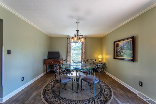 dining room with ornamental molding, dark hardwood / wood-style floors, and a notable chandelier