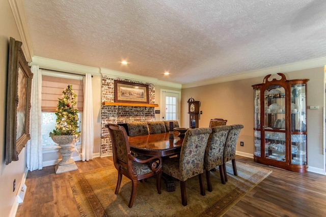 dining room featuring crown molding, dark hardwood / wood-style floors, and a textured ceiling