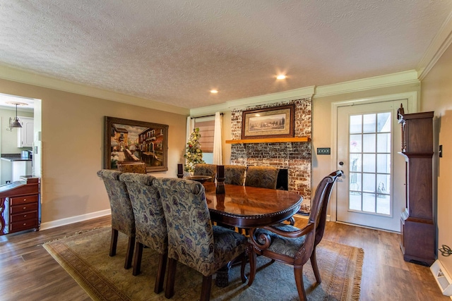 dining room with crown molding, dark hardwood / wood-style floors, and a textured ceiling