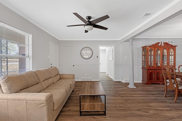 living room featuring decorative columns, crown molding, ceiling fan, and dark hardwood / wood-style flooring