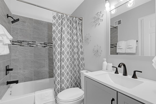 full bathroom featuring vanity, shower / bathtub combination with curtain, and toilet