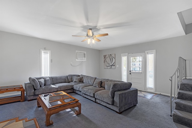 carpeted living room with an AC wall unit and ceiling fan