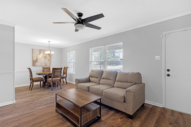 living room featuring wood-type flooring, ceiling fan with notable chandelier, and crown molding