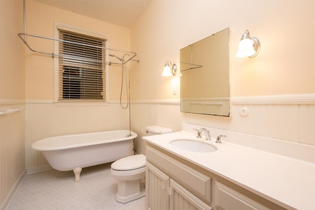 bathroom with tile patterned flooring, vanity, a washtub, and toilet