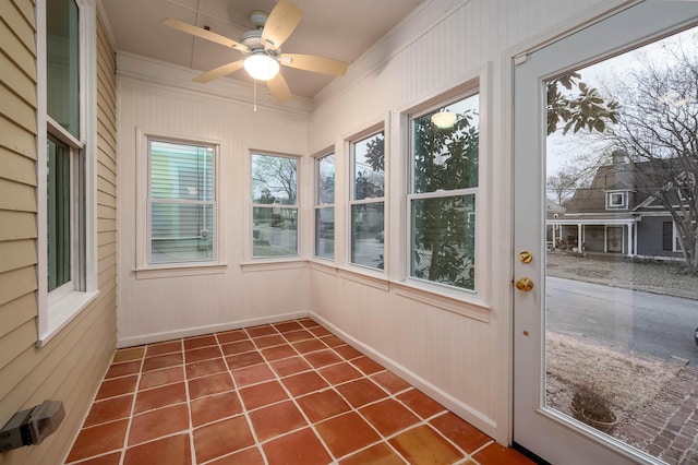 unfurnished sunroom with ceiling fan