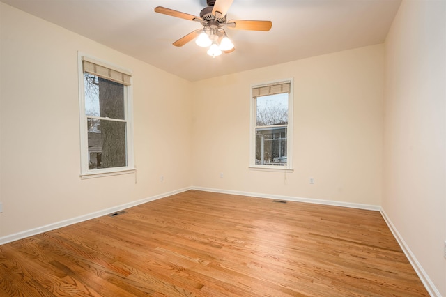 spare room featuring ceiling fan and light hardwood / wood-style flooring