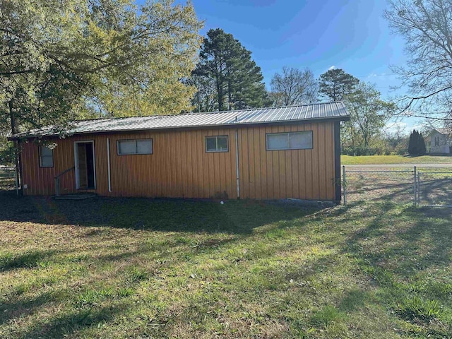 view of outbuilding with a yard