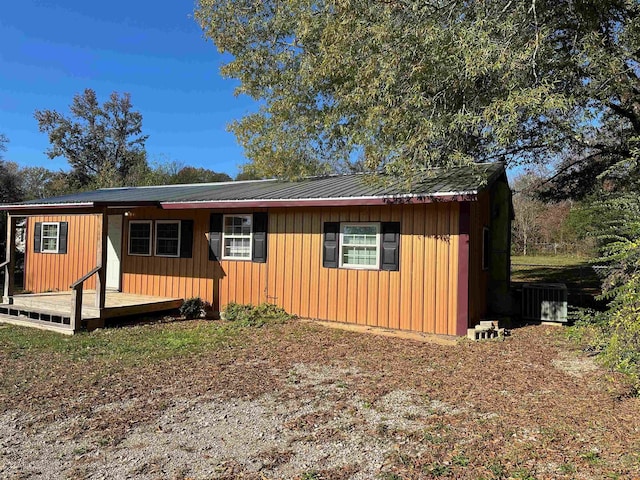 ranch-style house with a deck and central AC unit